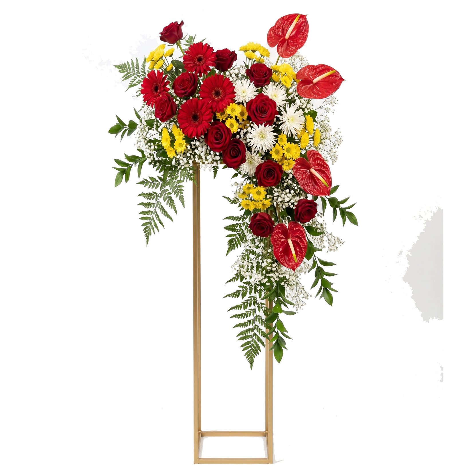 Tall golden stand supports a lush bouquet of red roses, red gerberas, yellow blooms and white filler flowers with greenery against a white background.